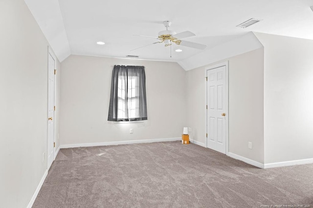 spare room with ceiling fan, light carpet, and lofted ceiling