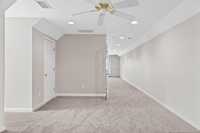 corridor with light carpet and lofted ceiling