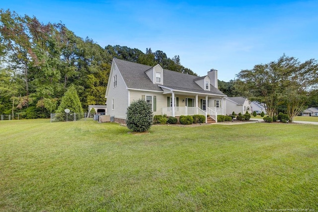 new england style home with a front lawn and covered porch