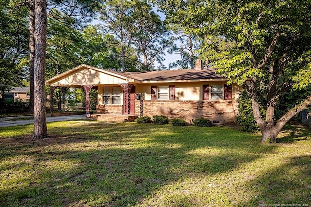 ranch-style house featuring a front yard and a carport