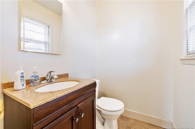 bathroom with tile patterned floors, vanity, and toilet