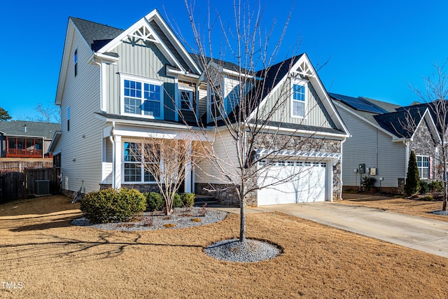 view of front of home featuring a garage and central AC unit