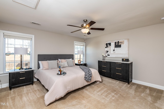 carpeted bedroom with ceiling fan and multiple windows