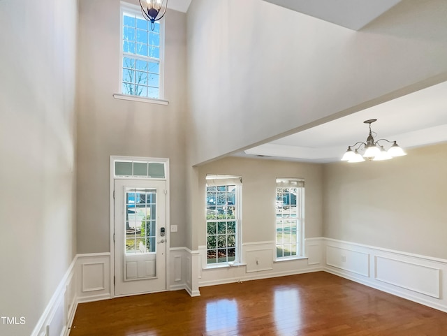 1012 Fulbright Dr, Morrisville, NC 27560 - foyer featuring a chandelier, wood finished floors, wainscoting, and a decorative wall