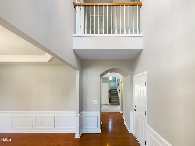 1012 Fulbright Dr, Morrisville, NC 27560 - hallway with arched walkways, stairs, wood finished floors, and a towering ceiling