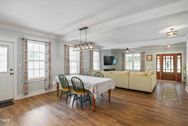 dining space featuring crown molding, baseboards, dark wood finished floors, and beamed ceiling