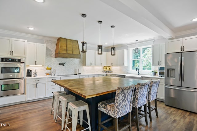 kitchen featuring stainless steel appliances and white cabinetry