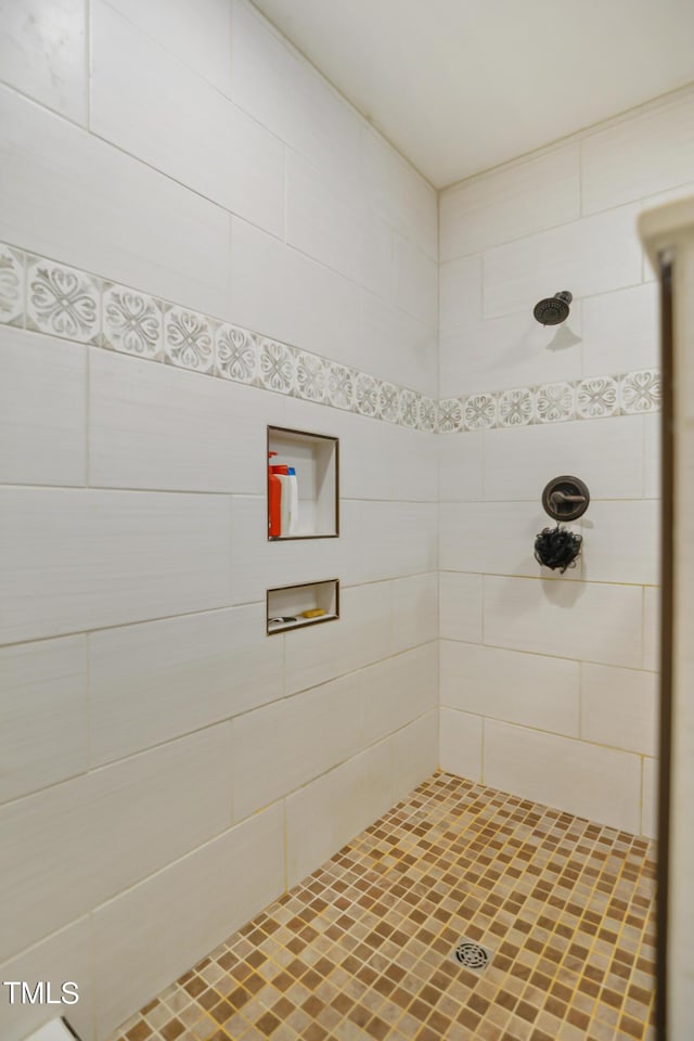 bathroom with tiled shower