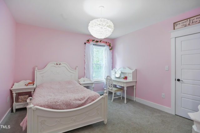 bedroom featuring baseboards, carpet, and an inviting chandelier