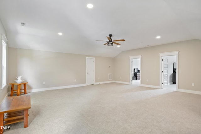 interior space featuring baseboards, visible vents, light colored carpet, vaulted ceiling, and recessed lighting