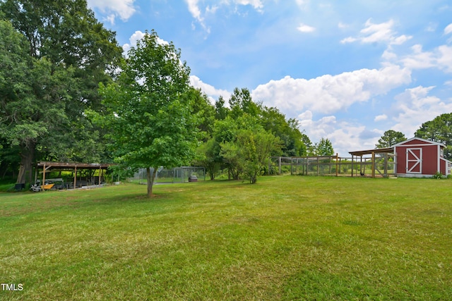 view of yard with an outdoor structure and fence