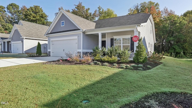 view of front of property featuring a front lawn, a porch, and a garage