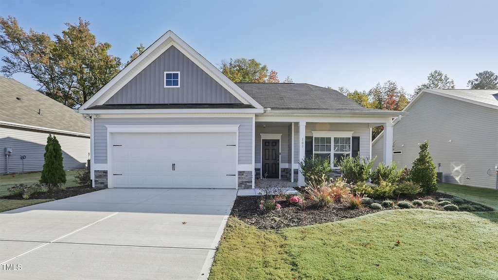 view of front of home with a garage and a front lawn