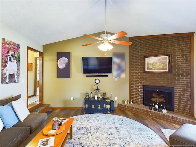 living room featuring a fireplace, wood-type flooring, ceiling fan, and lofted ceiling