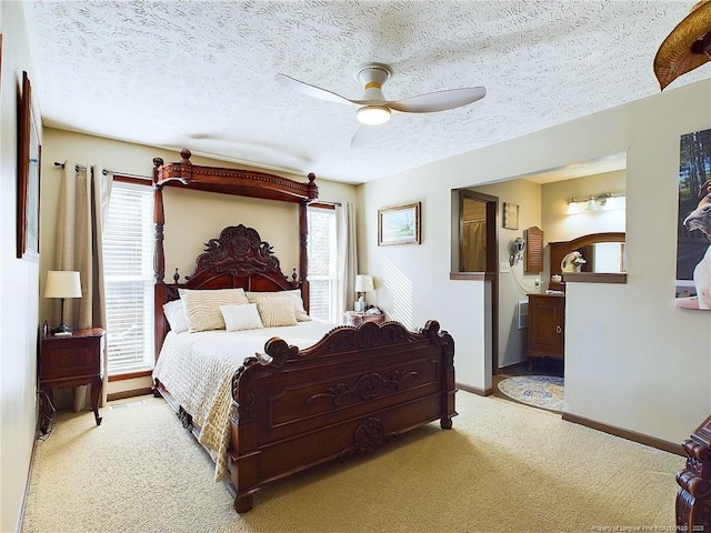 bedroom featuring multiple windows, light carpet, ceiling fan, and a textured ceiling