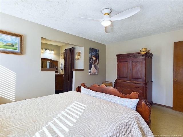 bedroom featuring ceiling fan, carpet floors, and a textured ceiling