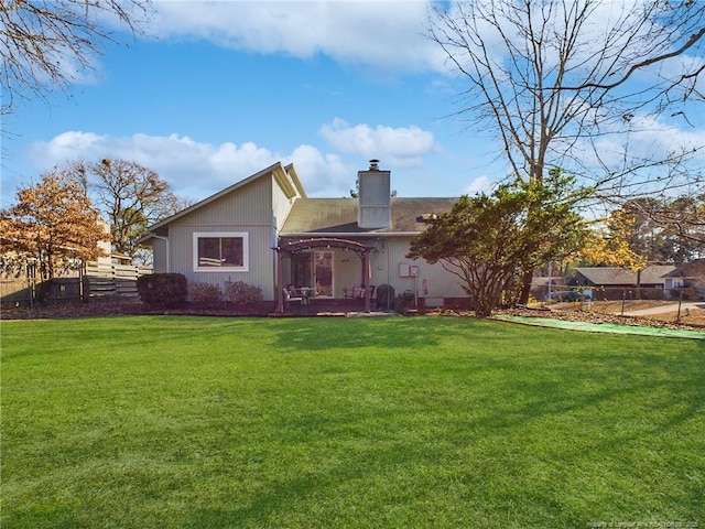 rear view of property with a yard