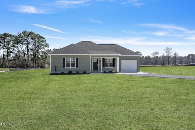 view of front of home with an attached garage, driveway, and a front yard