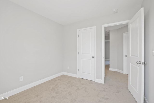 unfurnished bedroom with carpet flooring and baseboards