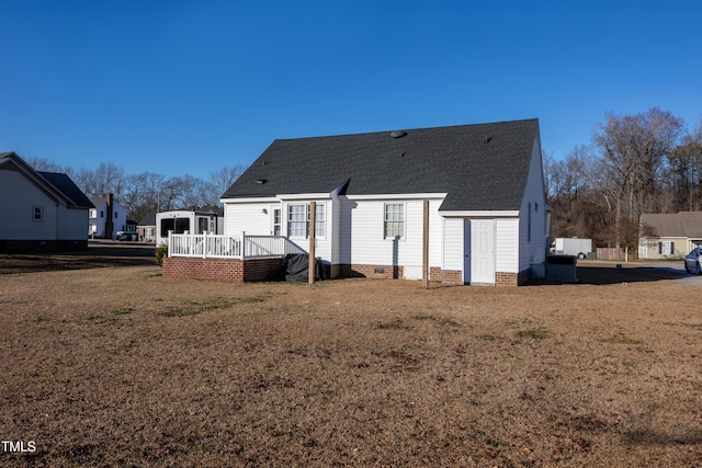 back of house featuring a yard and a wooden deck