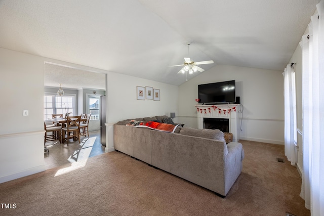 living room featuring carpet, ceiling fan, and lofted ceiling