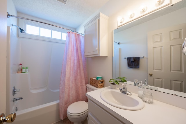 full bathroom featuring vanity, shower / bath combination with curtain, a textured ceiling, and toilet