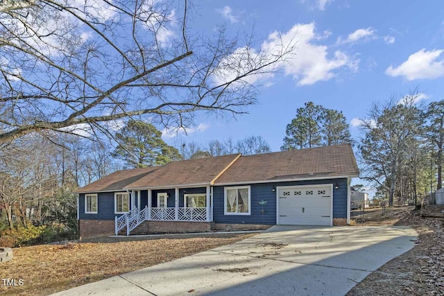 ranch-style house featuring covered porch and a garage