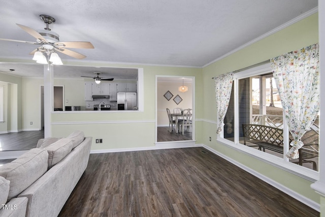 unfurnished living room with wood-type flooring, ceiling fan, and ornamental molding