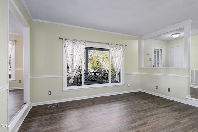 unfurnished room with dark hardwood / wood-style floors, ornamental molding, and a textured ceiling