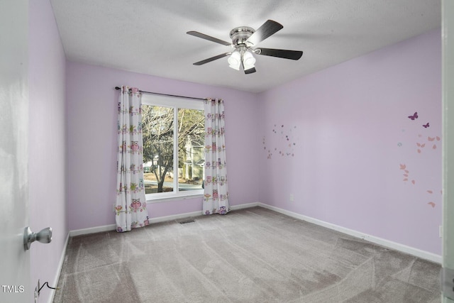 unfurnished room featuring light colored carpet and ceiling fan