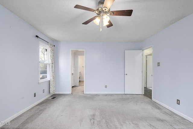 carpeted empty room with ceiling fan