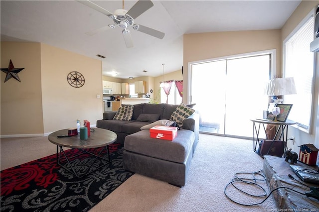 carpeted living room featuring ceiling fan and lofted ceiling