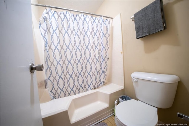 bathroom featuring shower / bath combo and toilet