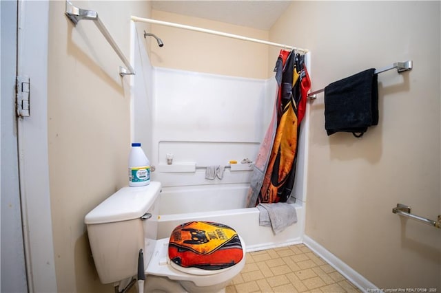 bathroom featuring shower / bathtub combination with curtain and toilet