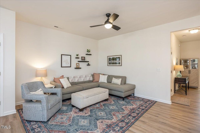 living room featuring ceiling fan and wood-type flooring