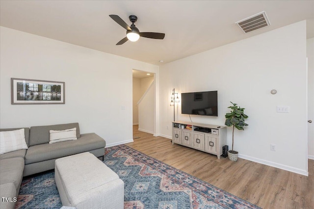 living room featuring ceiling fan and light wood-type flooring