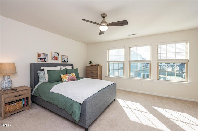 bedroom featuring ceiling fan and light carpet