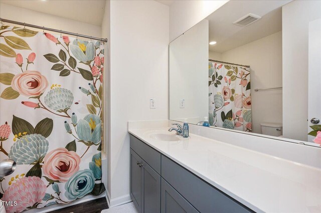 bathroom featuring toilet and vanity