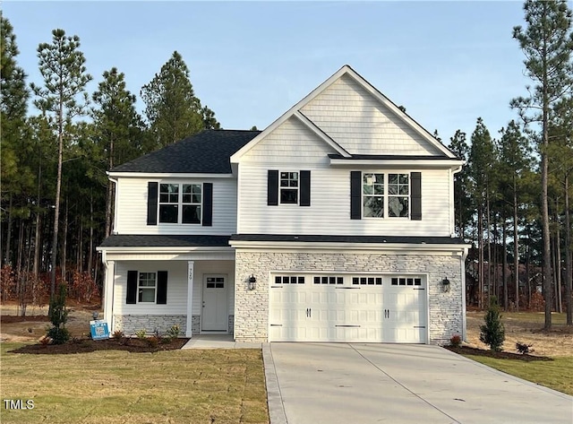 view of front property featuring a front lawn and a garage