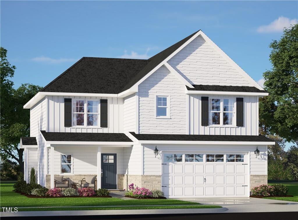 view of front of home featuring a front lawn and a garage