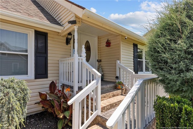 property entrance with a shingled roof