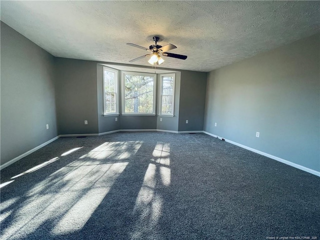 empty room with a textured ceiling and ceiling fan