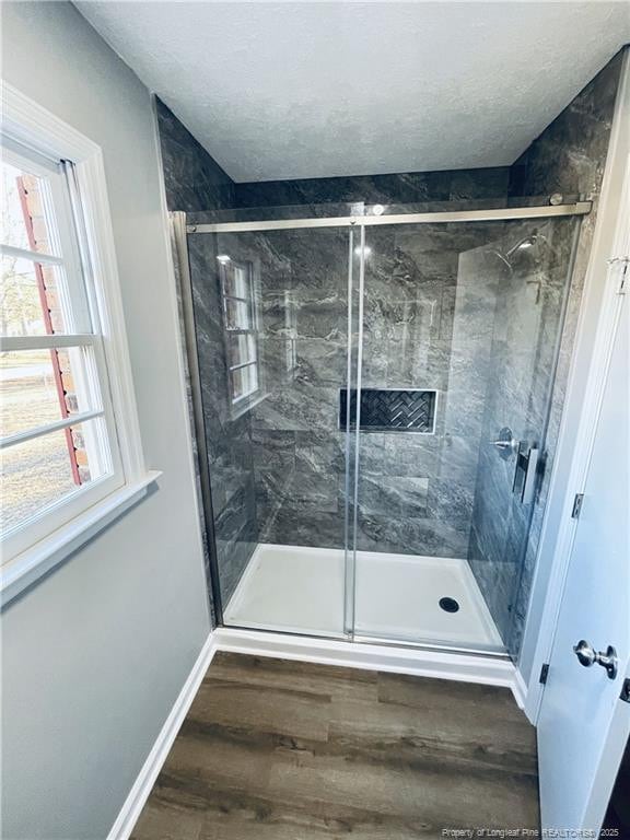 bathroom featuring hardwood / wood-style floors and a shower with door