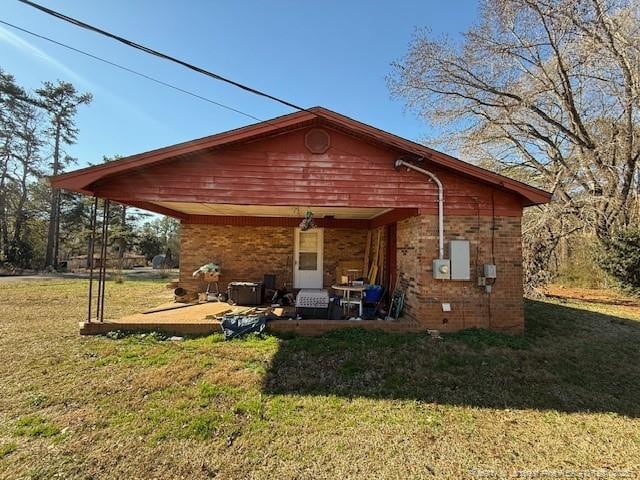 back of property featuring a yard