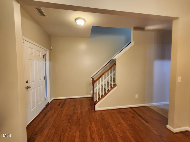 entryway with dark hardwood / wood-style flooring