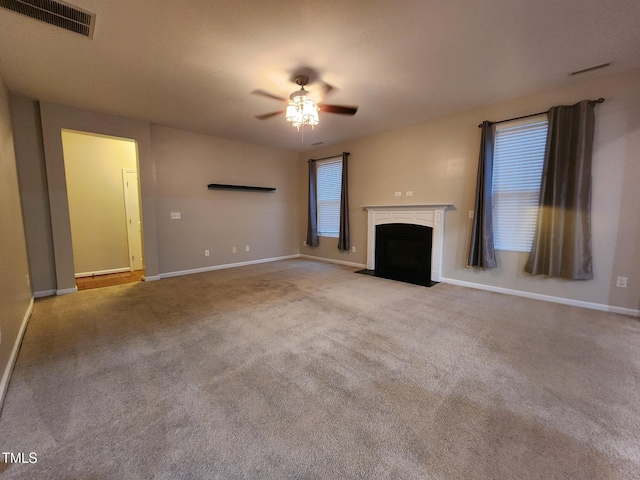 unfurnished living room featuring light colored carpet and ceiling fan