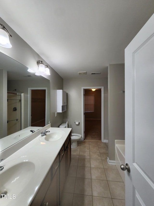 full bathroom with tile patterned floors, separate shower and tub, vanity, and toilet