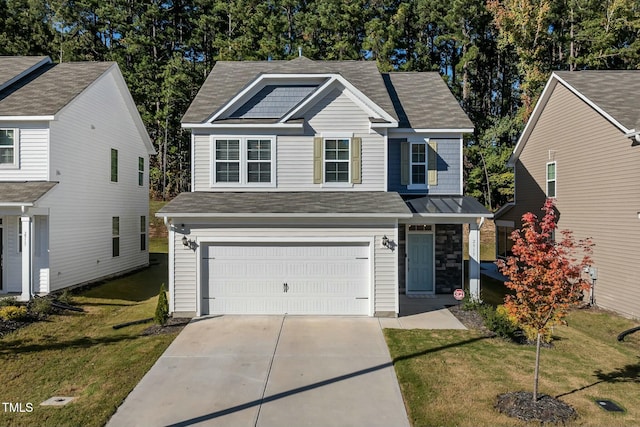 view of front facade with a front yard and a garage