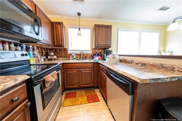 kitchen with crown molding, a healthy amount of sunlight, sink, and stainless steel appliances