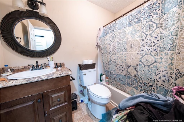 bathroom featuring a shower with curtain, vanity, toilet, and a textured ceiling